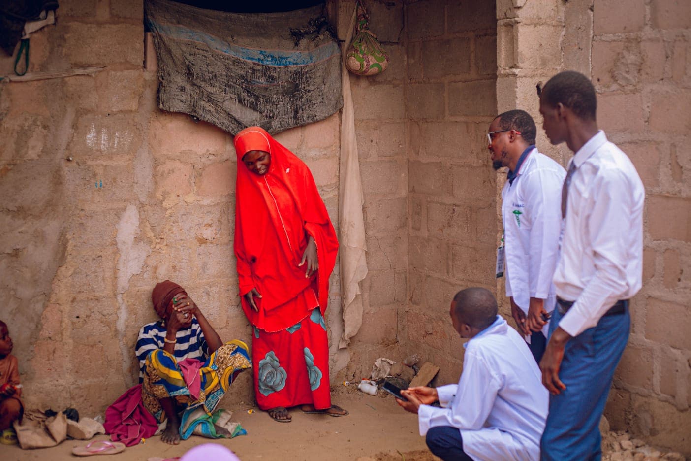 Afya1 clinicians engaging families during a community outreach visit