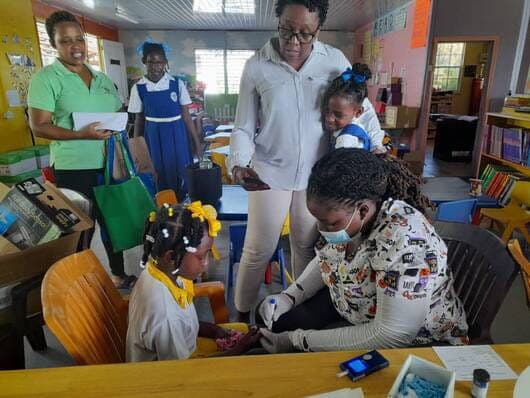 Afya1 team supporting school-based health screening for children